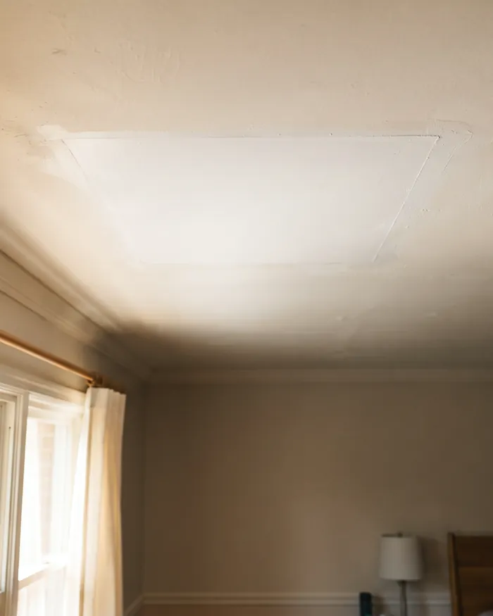 A wall with a patched hole textured and painted to match